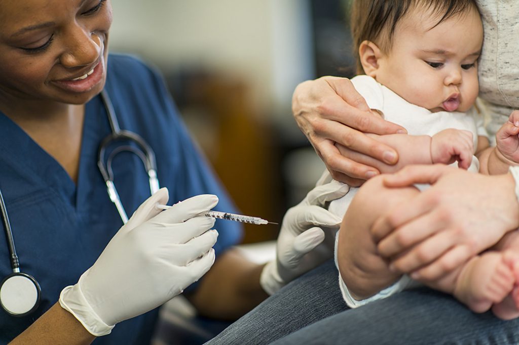 Doctor giving baby a vaccination