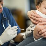 Doctor giving baby a vaccination